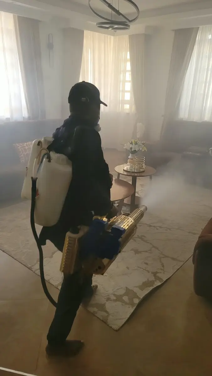 PrimeMax technician carrying out cockroach treatment in a home