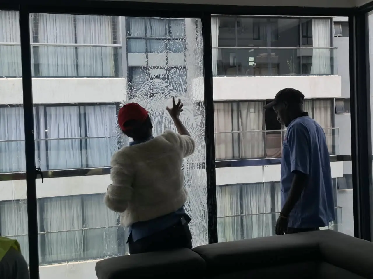 PrimeMax team cleaning large apartment windows