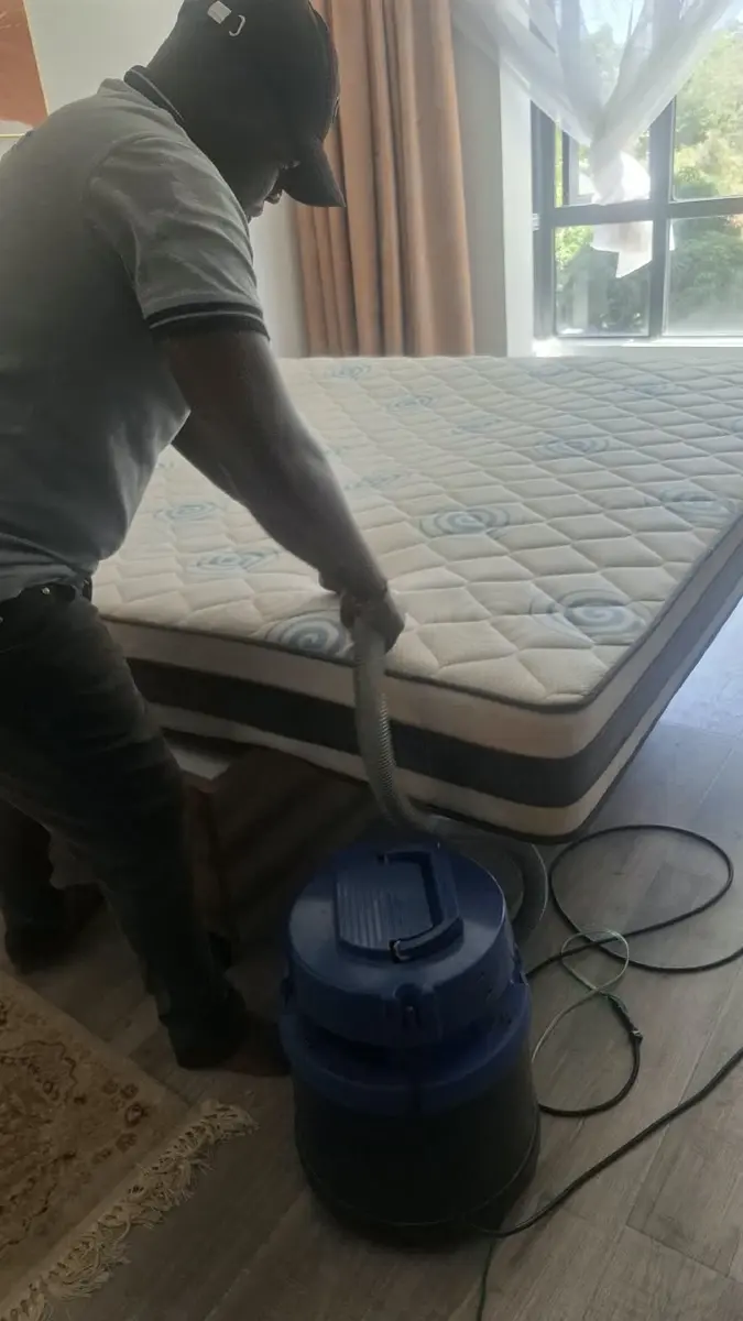 PrimeMax technician vacuuming a mattress before wet cleaning