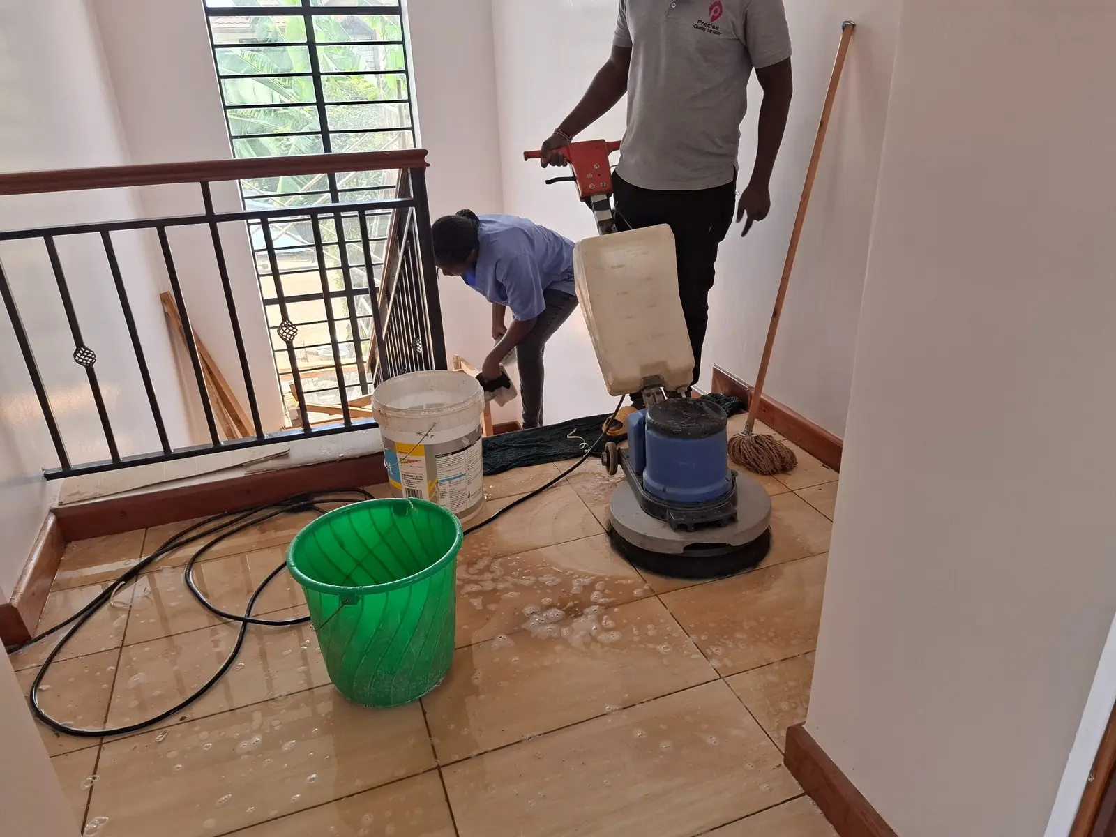 PrimeMax team machine scrubbing a floor after construction work