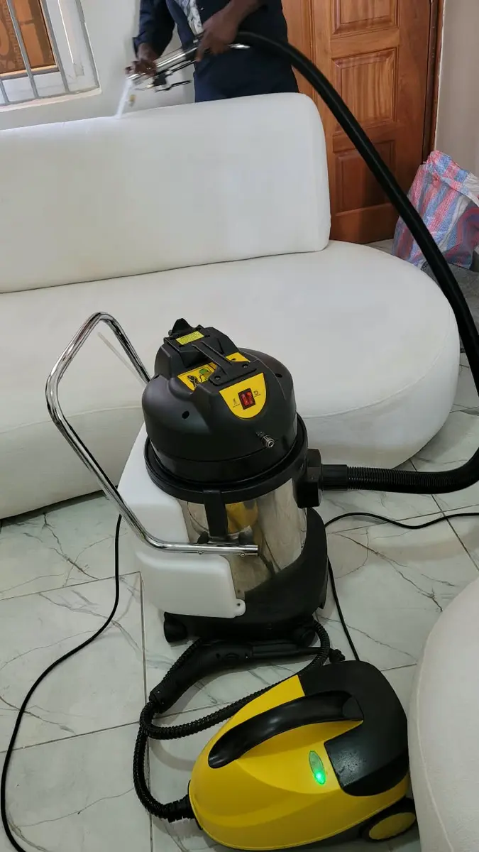 PrimeMax technician extracting dirt and water from a sofa